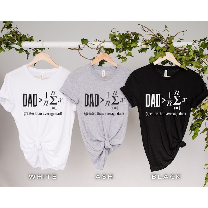 May include: Three t-shirts in white, ash grey, and black with the text "DAD > 1/n &Sigma;(i=1 to n) x(i) (greater than average dad)" printed on the front.