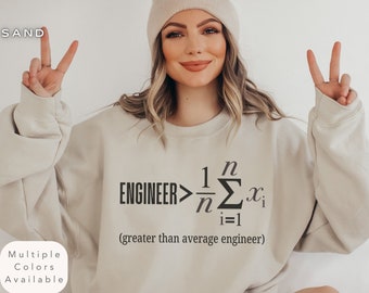 May include: A beige sweatshirt with a black graphic that reads "ENGINEER> 1/n Σ(i=1 to n) x_i (greater than average engineer)".