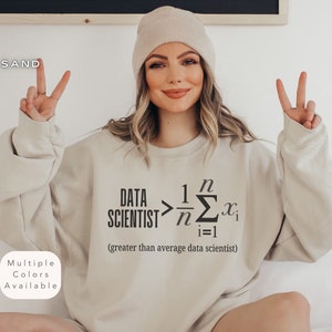 Peut inclure: Un sweat-shirt beige avec le texte "DATA SCIENTIST > 1/n Σ(i=1 to n) x_i (greater than average data scientist)" imprimé sur le devant.