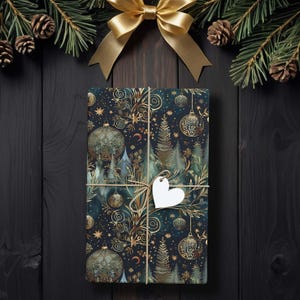 May include: A wrapped gift with a festive Christmas design. The wrapping paper features a dark blue background with gold ornaments, trees, and stars. A gold bow and pine branches with pinecones decorate the top. A white heart-shaped tag is tied with twine.