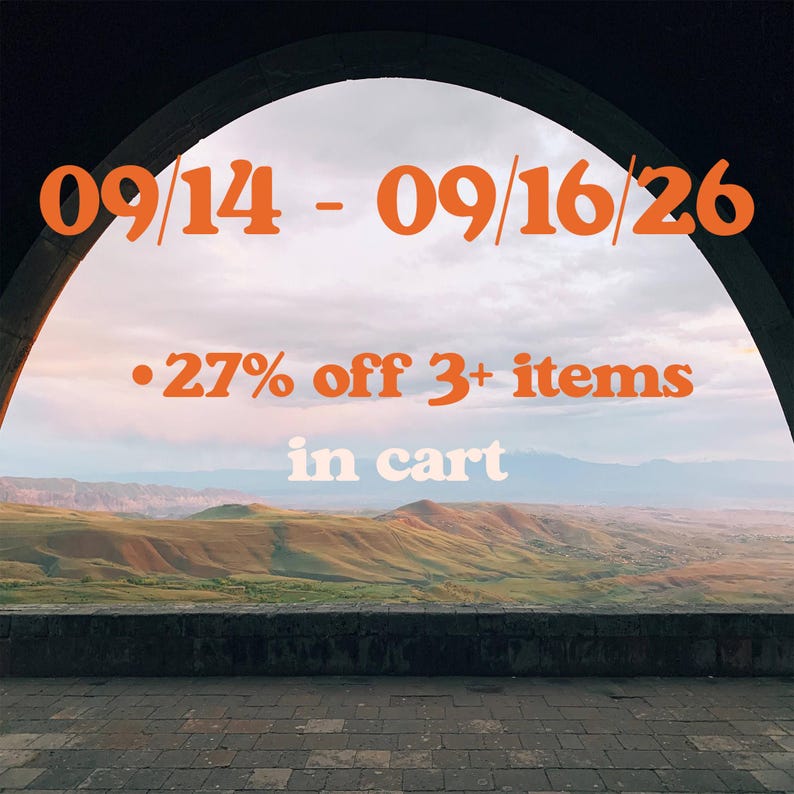 a scenic view of a mountainous landscape through an archway, with a sale announcement overlaid on the image.