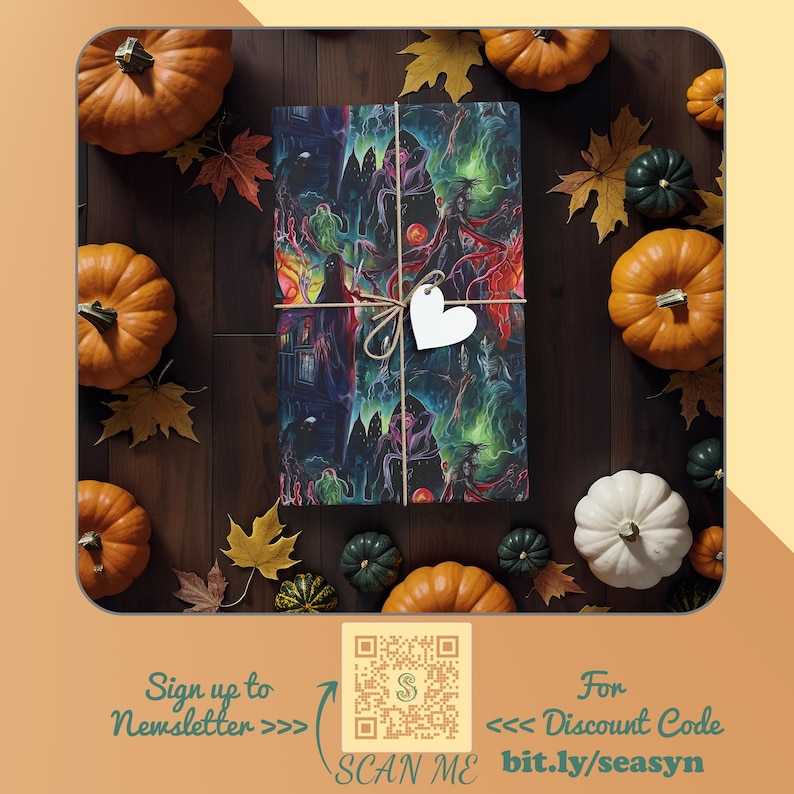 May include: A wrapped gift box with a spooky Halloween design featuring a house, trees, and figures. The box is tied with twine and a white heart-shaped tag. The background features fall leaves and pumpkins.
