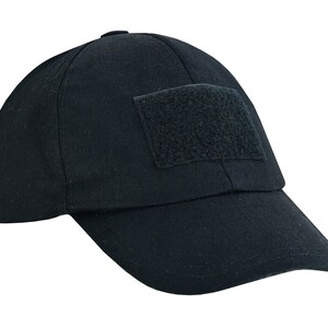 May include: A black baseball cap with a velcro patch on the front.