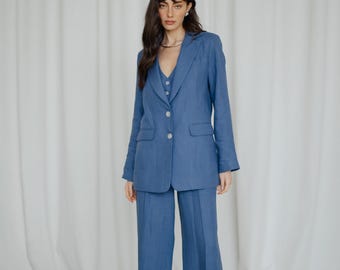May include: A blue linen blazer and matching wide-leg pants. The blazer has a single button closure and a notched lapel.