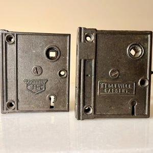 May include: Two antique door lock plates, one with the inscription "CORBIN USA" and the other with the inscription "T.H.VILLE SARGENT".