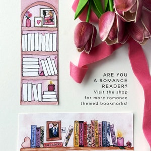 May include: Two watercolor illustrations of bookshelves with books and candles. The top image features a bookshelf with a pink background and a small picture frame with a couple inside. The bottom image features a bookshelf with a white background and a variety of books with titles like "Fake Lovers", "Grumpy Sunshine", "Historical Romance", "Spicy Lovers", "Enemies", "Second Chance", "Dark Romance", and "Slow Burn". The text "ARE YOU A ROMANCE READER? Visit the shop for more romance themed bookmarks!" is written below the images.