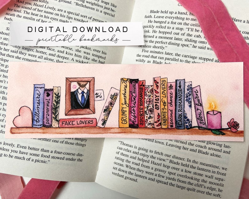 May include: A set of ten watercolor bookmarks featuring book covers with various titles, including "Billionaire", "Paranormal", "Fake Lovers", "Grumpy Sunshine", "Historical Romance", "Sports Romance", "Enemies & Spicy Lovers", "Second Chance", "Dark Romance", and "Slow Burn". The bookmarks are arranged on a shelf with a pink heart, a small potted plant, and a lit candle.