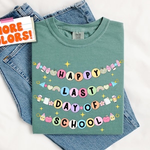 May include: Light green t-shirt with a colorful banner that reads "Happy Last Day of School".