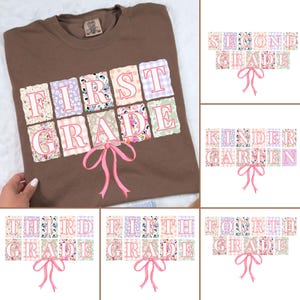 May include: A brown sweatshirt with the words "FIRST GRADE" in a patchwork design. Each letter is in a different floral or gingham pattern, outlined in pink. A pink bow is below the text. Additional images show "SECOND GRADE", "KINDERGARTEN", "THIRD GRADE", "FIFTH GRADE", and "FOURTH GRADE".