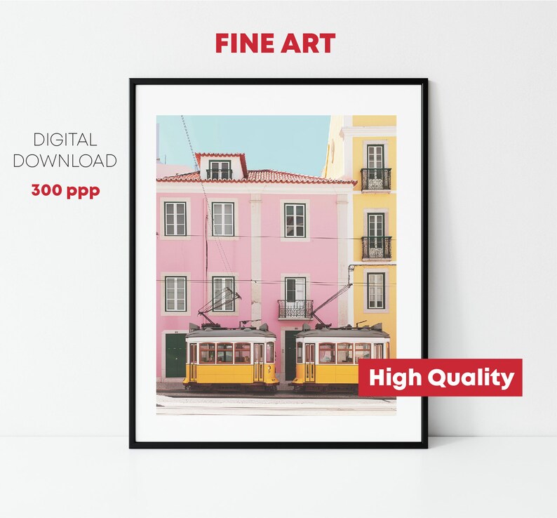 May include: A digital print of a photograph of two yellow trams parked in front of a pink and yellow building. The building has windows and balconies. The image is high quality and suitable for printing.