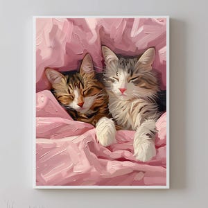May include: Two cats, one tabby and one white with gray markings, are sleeping together under a pink blanket. The cats are curled up together and their eyes are closed.