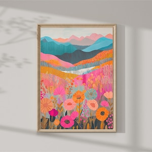 Puede incluir: Una impresión artística enmarcada que representa un paisaje colorido con montañas y flores silvestres. La obra de arte presenta una paleta vibrante de rosa, naranja, turquesa y amarillo. Las flores en primer plano están en plena floración.