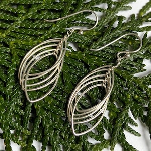 May include: A white ceramic mug with a black handle and the text "But First, Coffee" in a black, bold font. The mug is on a white surface.