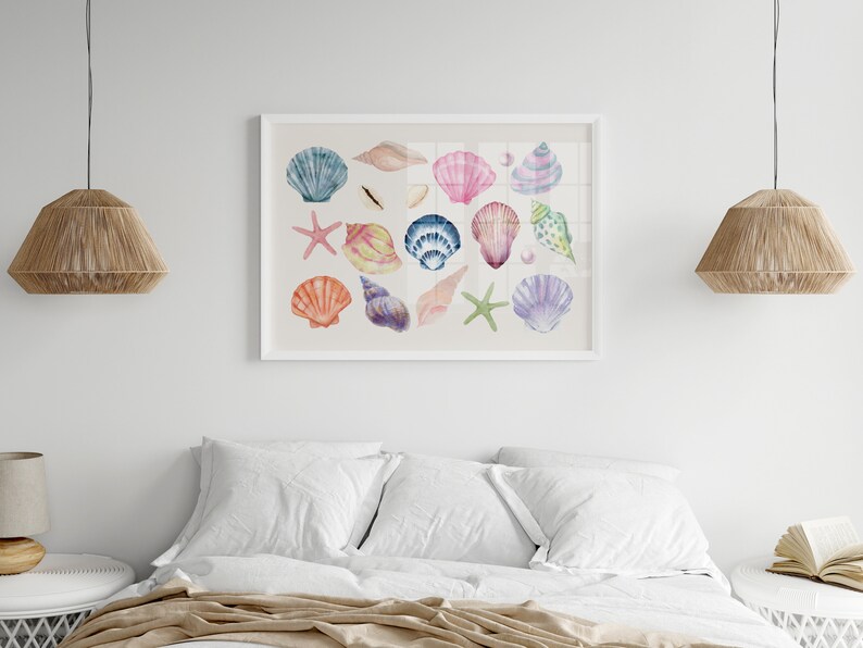 May include: A white framed print with a watercolor illustration of various seashells in shades of pink, blue, purple, and orange. The seashells are arranged in a random pattern on a white background.