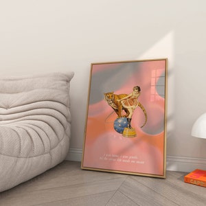 May include: A framed print with a pink and blue background featuring a woman in a red and white costume riding a tiger on a ball. The text below reads "I can tame, I was gentle, all the circus life made me mean."