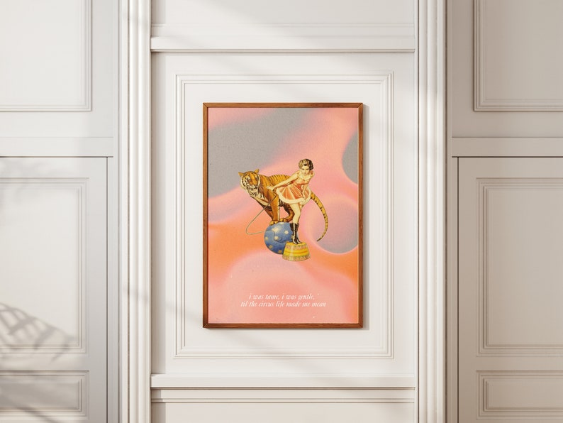 May include: A vintage-style illustration of a woman in a pink dress riding a tiger on a blue and white ball. The background is a pink and gray gradient with the text "I was home, I was gentle, till the circus life made me mean."