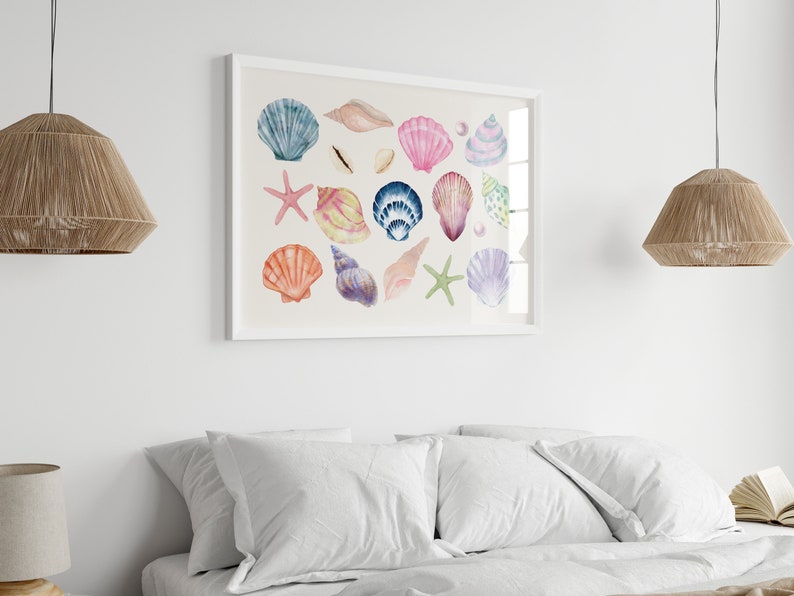 May include: A framed watercolor painting of various seashells in shades of pink, blue, purple, and orange. The shells are arranged in a random pattern on a light beige background.
