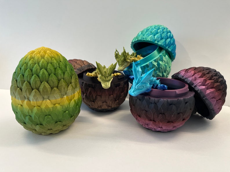 May include: Five dragon eggs, each with a different color and design. The eggs are made of a textured material and have a realistic look. Some of the eggs are open, revealing a small dragon inside.
