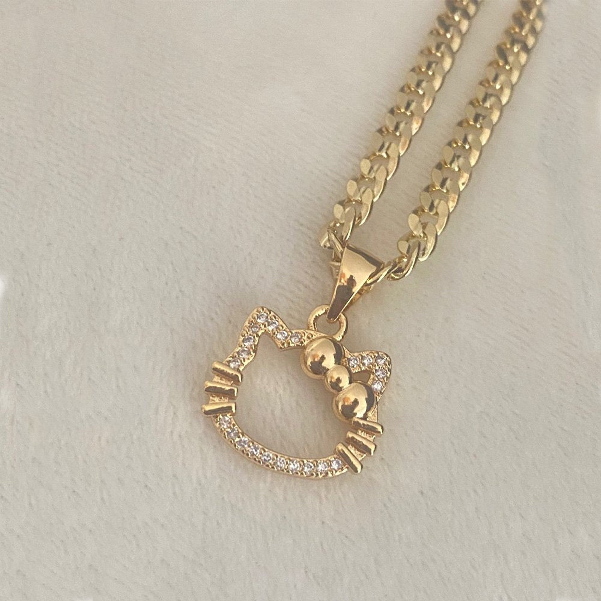 Hello kitty gold pendant discount
