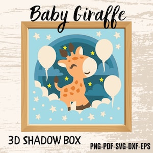 May include: A framed 3D shadow box featuring a cartoon giraffe with a light orange body and brown spots. The giraffe is set against a blue background with white clouds, stars, and balloons. The text "Baby Giraffe" is at the top.