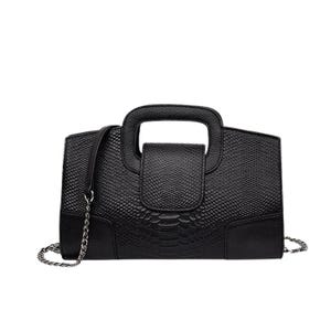 May include: Black handbag with a textured, snake-like pattern. Features a top handle and a detachable chain strap. The bag has a rectangular shape with a flap closure and a silver-tone chain.