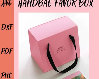 May include: A pink handbag favor box with black handles. The box has the words "Merci Beaucoup" printed on the front. The image also includes the words "SVG", "DXF", "PDF", and "PNG".