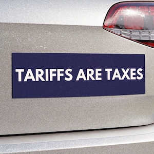 May include: A silver car with a blue bumper sticker that reads "Tariffs Are Taxes".