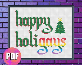 May include: Cross stitch pattern featuring the text "Happy Holidays" in a gothic font. The word "Happy" is in green with red outlines, and the word "Holidays" is in a rainbow gradient. A green Christmas tree with a yellow star and red ornaments is to the right of the text.