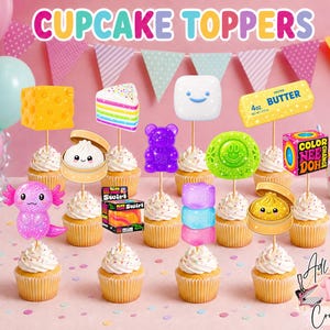 May include: A collection of cupcake toppers featuring various colorful designs including a block of cheese, a rainbow cake slice, a smiling marshmallow, a stick of butter, a purple gummy bear, a green smiley face, and an axolotl.