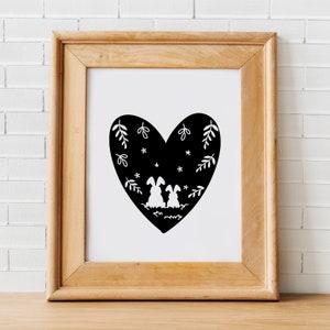May include: A black and white illustration of two bunnies sitting inside a heart-shaped silhouette. The heart is filled with small white stars and stylized leaves.