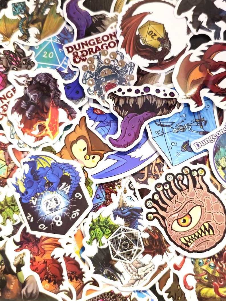 May include: A collection of colorful fantasy-themed stickers featuring dragons, dice, and monsters. The stickers have various designs, including a blue dragon, a red dragon, and a creature with multiple eyes. Some stickers have the text "Dungeon & Dragon".