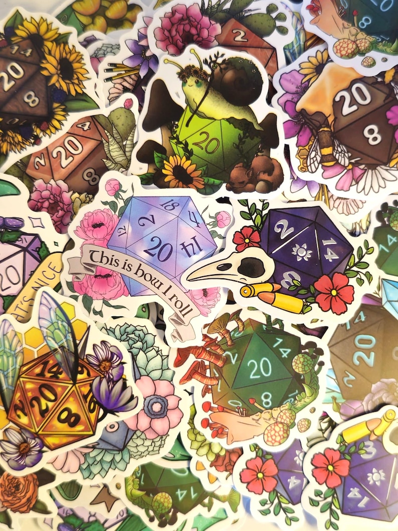 May include: A collection of colorful stickers featuring fantasy-themed designs. The stickers include various polyhedral dice, floral arrangements, and whimsical creatures like snails and bees. Some stickers have text that reads "This is how I roll."