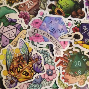 May include: A collection of colorful stickers featuring dice, flowers, mushrooms, and insects. Some stickers have the number 20 on them, and one reads "This is how I roll."