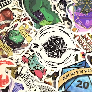 May include: A collection of colorful stickers featuring fantasy and role-playing game themes. Designs include dice, dragons, and text like "Dungeons & Dragons" and "Roll". The stickers vary in size and shape, with a mix of illustrations and text.