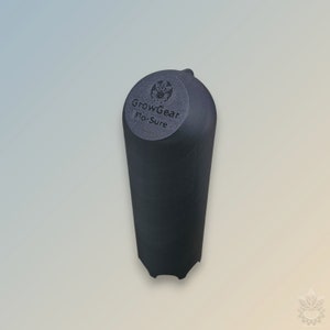 Puede incluir: Un tapón de botella de plástico negro con una parte superior redonda y un logotipo que dice "GrowGear Flo-Sure".