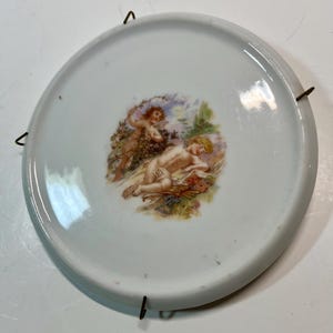 May include: A set of three ceramic mugs with a speckled, matte finish. The mugs are in shades of cream, light gray, and dark gray. Each mug has a simple, minimalist design and a rounded handle. Perfect for coffee or tea.