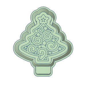 May include: A light green Christmas tree-shaped cookie cutter. The cutter features a star at the top and decorative swirls and stars within the tree's outline. The base of the tree has a rectangular shape.