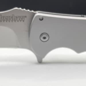 May include: A silver folding knife with a black handle and the word "Spyderco" engraved on the blade.