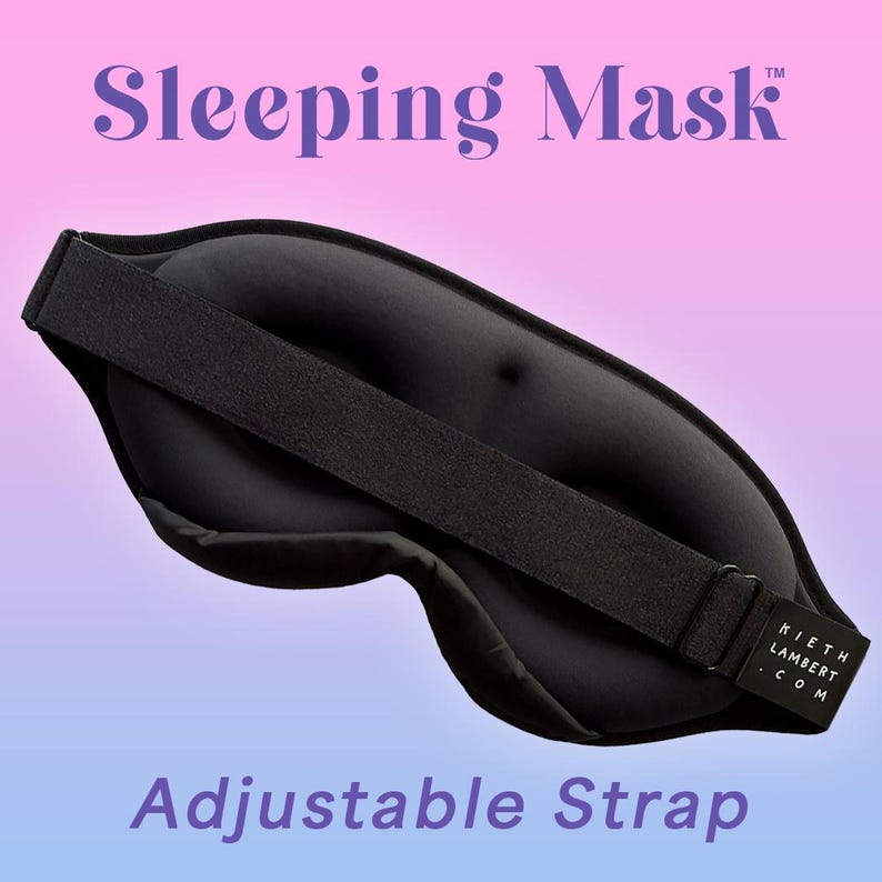 May include: Black sleeping mask with an adjustable strap. The mask has a contoured design and a wide strap for comfort. The text "Sleeping Mask" is at the top, and "Adjustable Strap" is at the bottom. The brand name "Kieth Lambert .com" is on the strap.