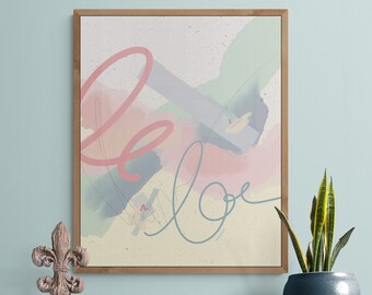 May include: A framed abstract art print with a pink, blue and green colour scheme. The print features the word "love" written in a stylised font.