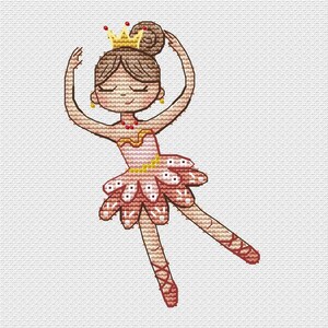 Peut inclure: Un motif de point de croix représentant une ballerine portant une couronne jaune, un tutu rose avec des accents blancs et des chaussons de danse rouges. La figurine a des cheveux bruns en chignon, un collier rouge et les bras levés sur un tissu blanc.