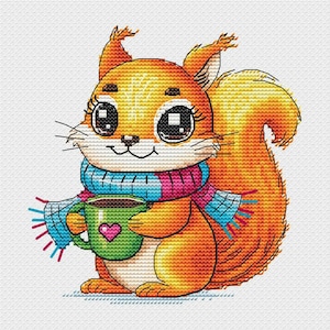 May include: A cross-stitch embroidery pattern featuring an orange squirrel with large dark eyes, wearing a blue and pink plaid scarf. The squirrel is holding a green mug decorated with a small pink heart, rendered in detailed cross-stitch texture.