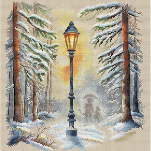 May include: Cross-stitch of a winter scene featuring a lamppost with a lit, orange-yellow lantern. Snow-covered trees line a path where two figures walk under an umbrella. The scene is set in a snowy forest with a warm, golden light.