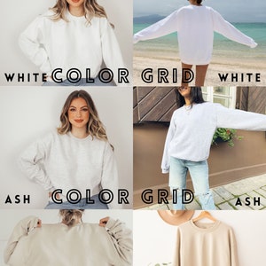 Op de afbeelding: Een kleurenkaart met drie verschillende kleuren sweatshirts: wit, as en zand. Elk sweatshirt is een ronde hals met lange mouwen.