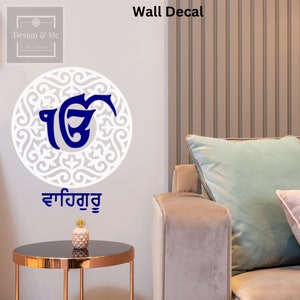 May include: A white wall decal with a blue and white design and text. The circular decal has an intricate pattern. The text "Wall Decal" is at the top. The decal is on a light grey wall.