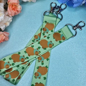 Capybara in a frog hat Lanyard | capybara Lanyard, lanyard, Frogcore, cottagecore, toad, brown frog, silly frog, hot spring, tangerine