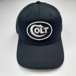 May include: Black trucker hat with a white Colt logo in an oval shape.