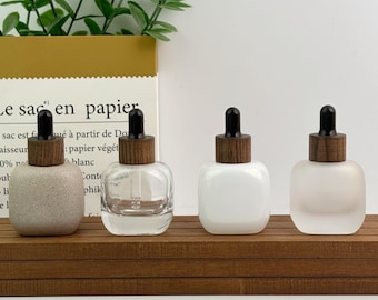 Frasco cuentagotas de vidrio transparente, frasco de suero recargable de 30 ml, frasco cuadrado para aceites esenciales con tapa de madera y cuentagotas negro, marcas de cuidado de la piel.