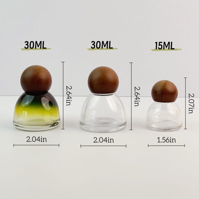 May include: Three glass bottles with wooden stoppers. The bottles are labeled 30ML and 15ML. The largest bottles are 2.64 inches tall and 2.04 inches wide. The smallest bottle is 2.07 inches tall and 1.56 inches wide. One bottle has a green and yellow gradient.