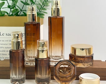 Frasco de loción de vidrio ámbar degradado, pulverizador y tarro para crema, envase de lujo para el cuidado de la piel, recipientes cosméticos recargables con bomba dorada.